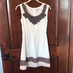 Ivory dress with grey ruffle detailing